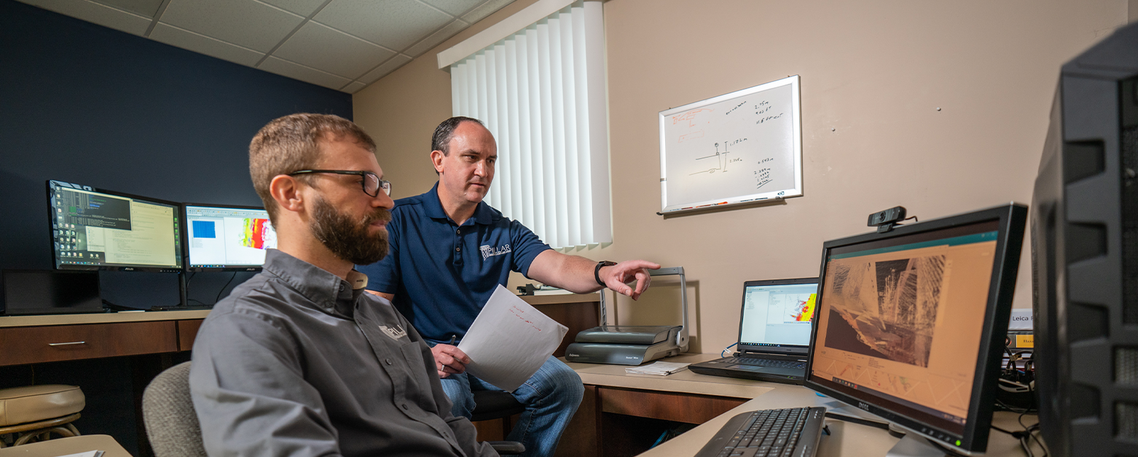 Two men working on a computer