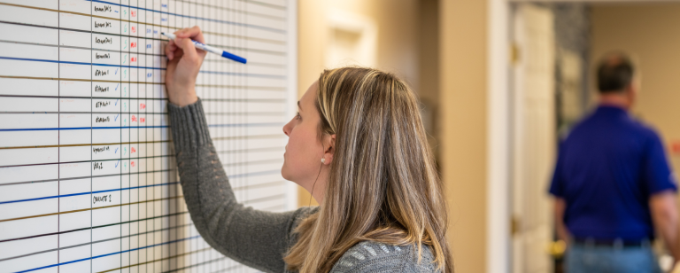 Woman writing on a whiteboard