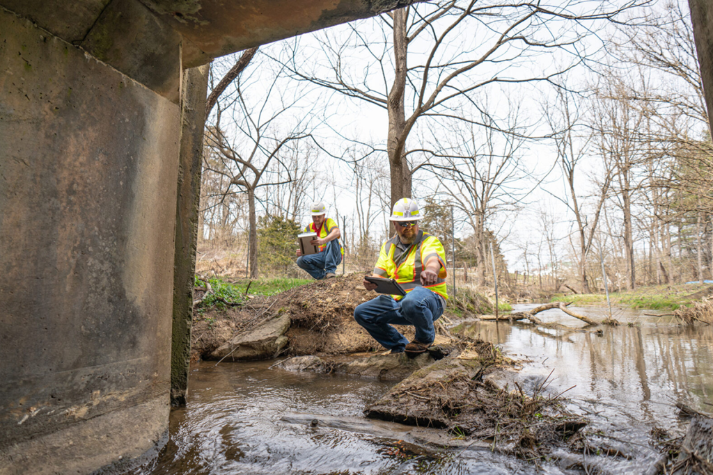 two men inspecting a pipe