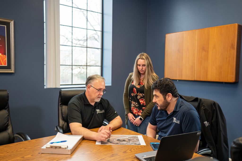 three employees in a meeting