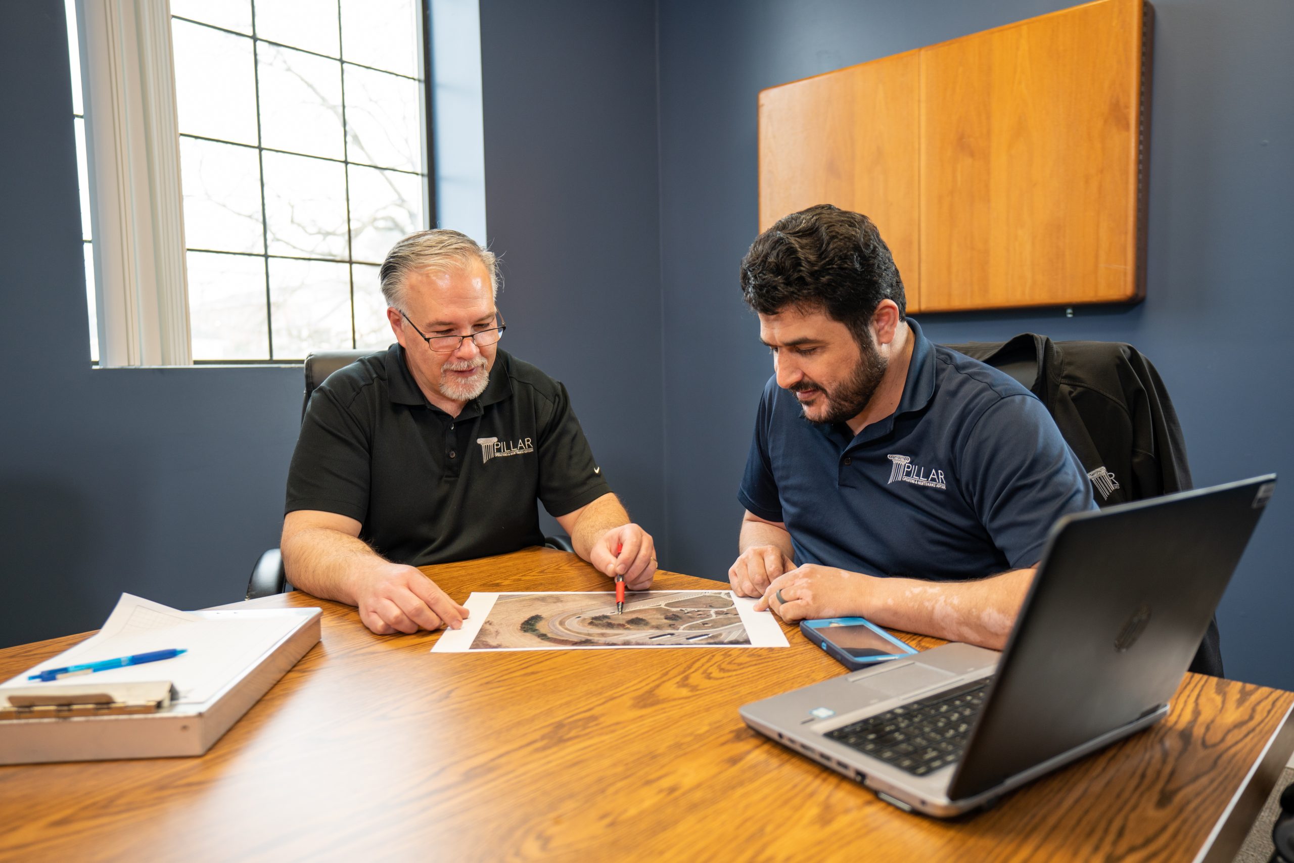 two men at a table assessing a plan