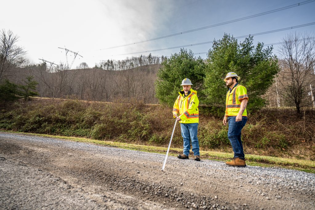 two workers taking measurements