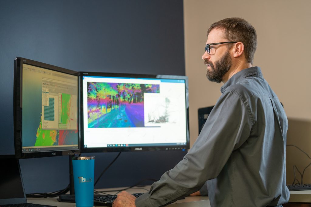 man at a computer looking at data