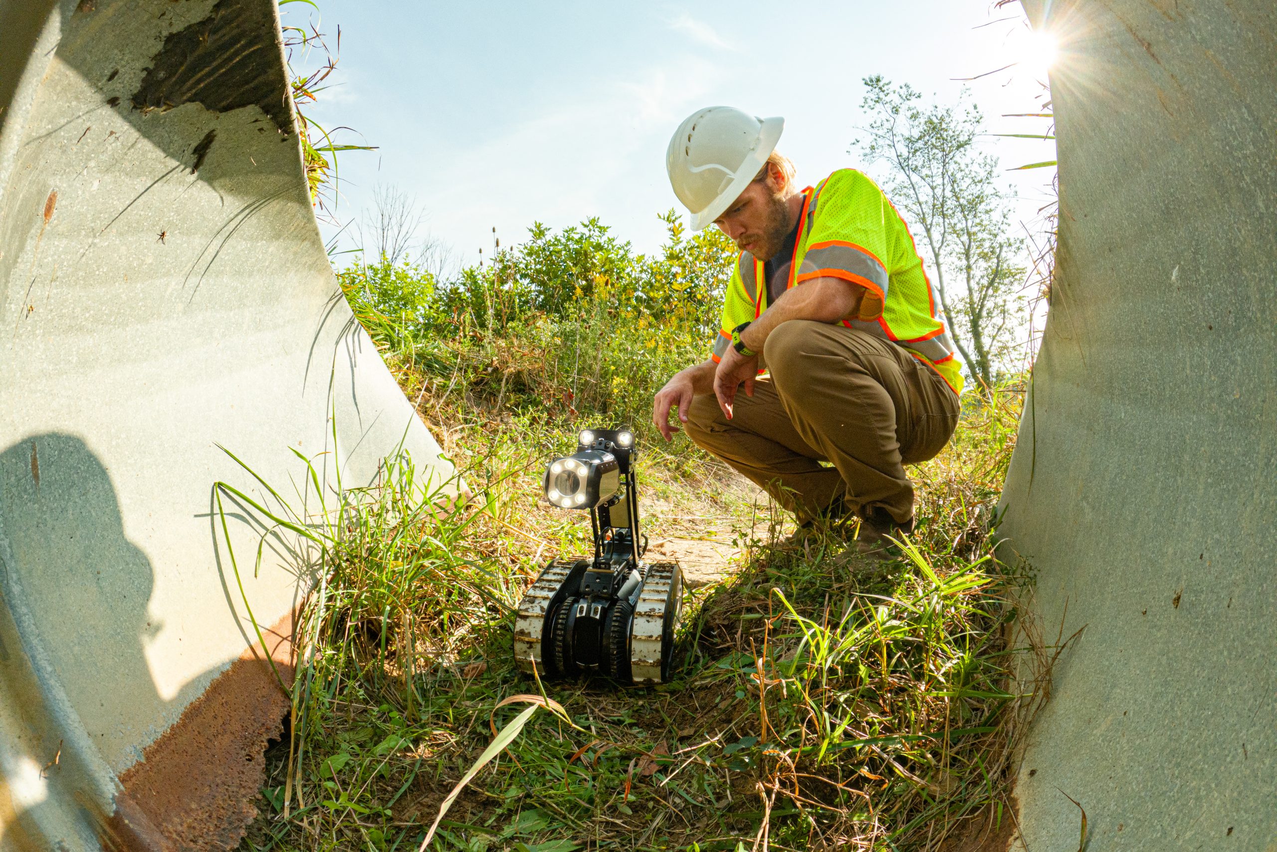 man testing pipe crawler by a pipe