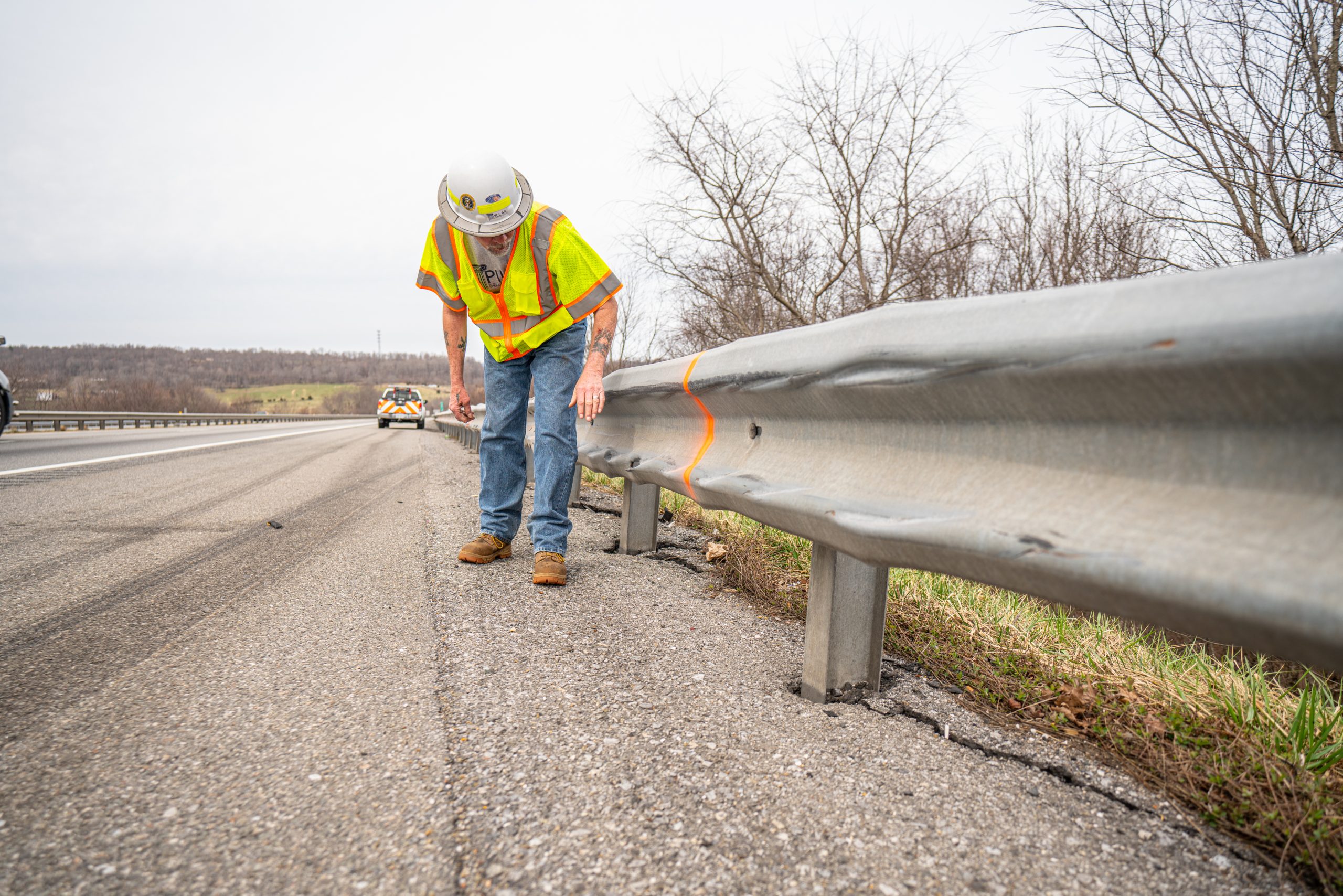 PILLAR Employee Inspecting Damaged Guardrail