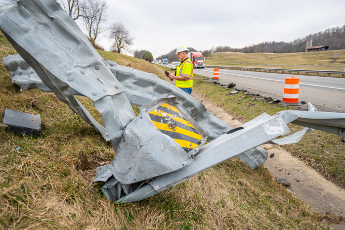 Damaged Guardrail w/ PILLAR Employee Inspecting